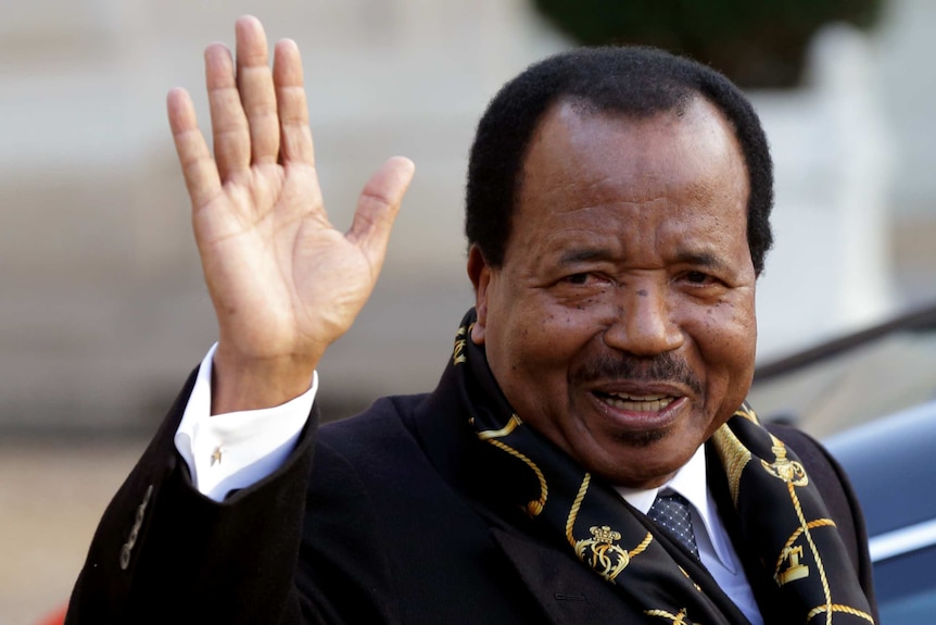President of Cameroon Paul Biya waves to supporters