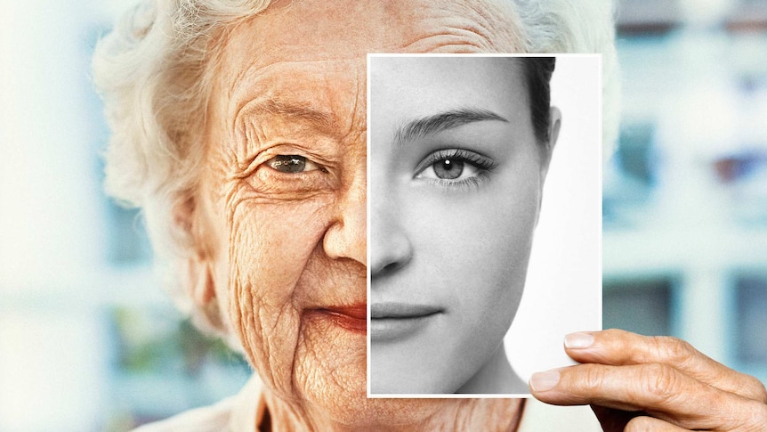 coloured portrait of older woman holding a black and white photo with half a younger woman's face against her own