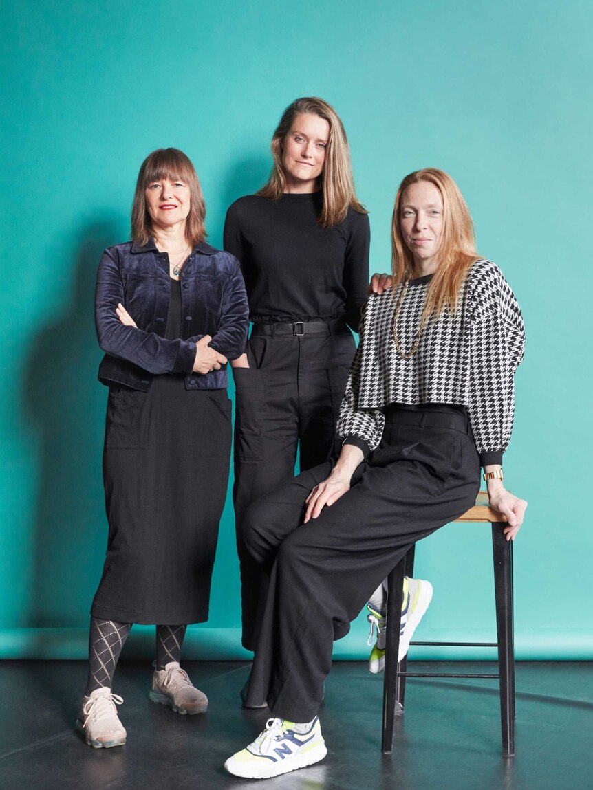 Portrait of choreographers Lucy Guerin, Stephanie Lake and Jo Lloyd with a turquoise backdrop