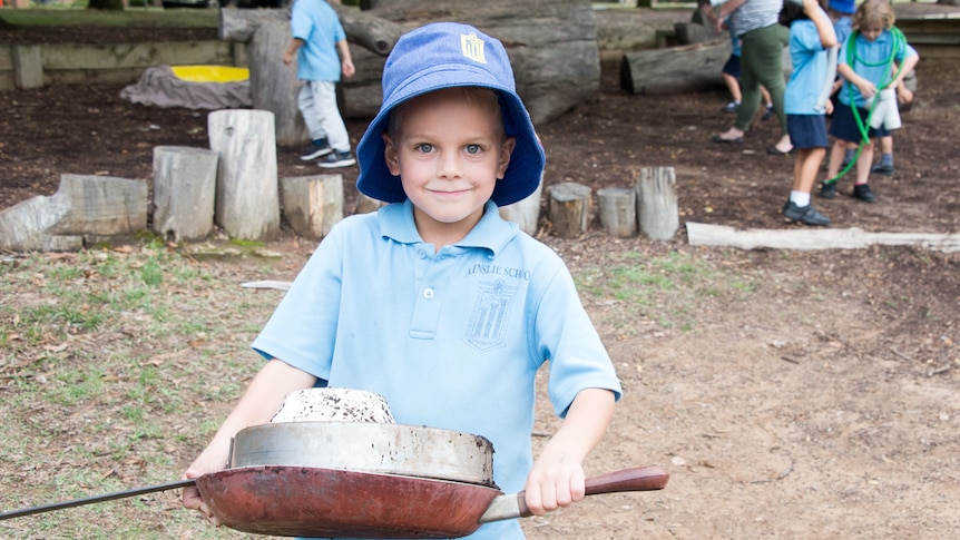 Year one student Luke playing with frying pans