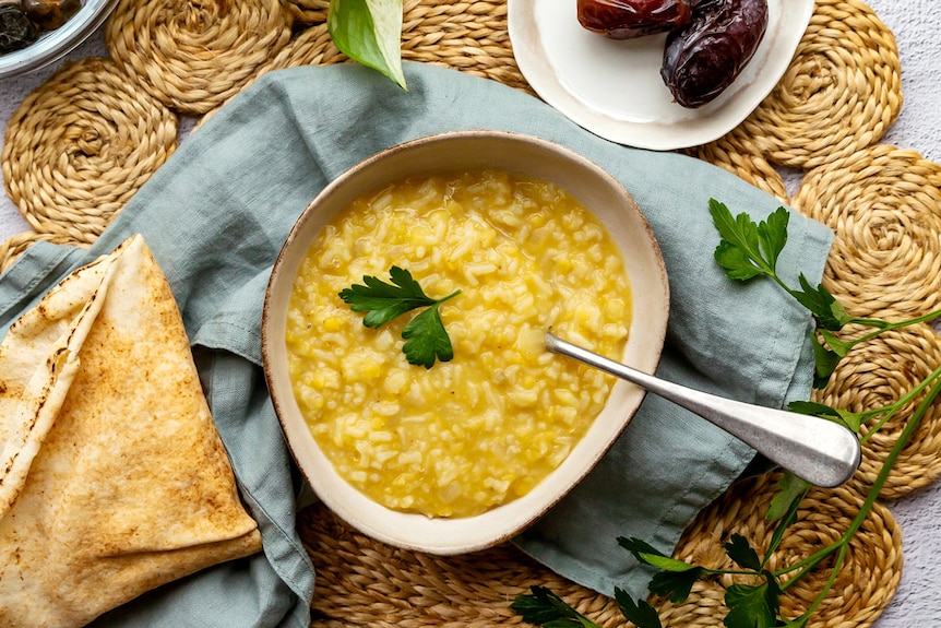 Bowl of lentil and rice soup, a simple and nourishing meal to serve when Ramadan fasting ends. 