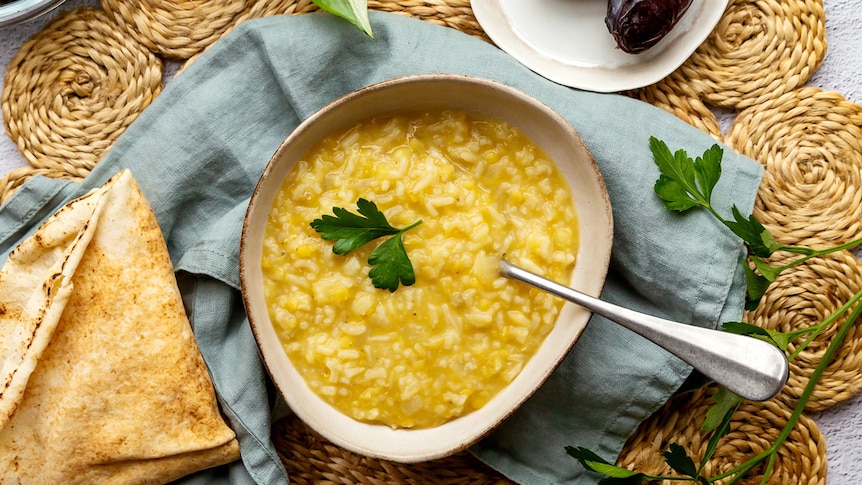 Bowl of lentil and rice soup, a simple and nourishing meal to serve when Ramadan fasting ends. 