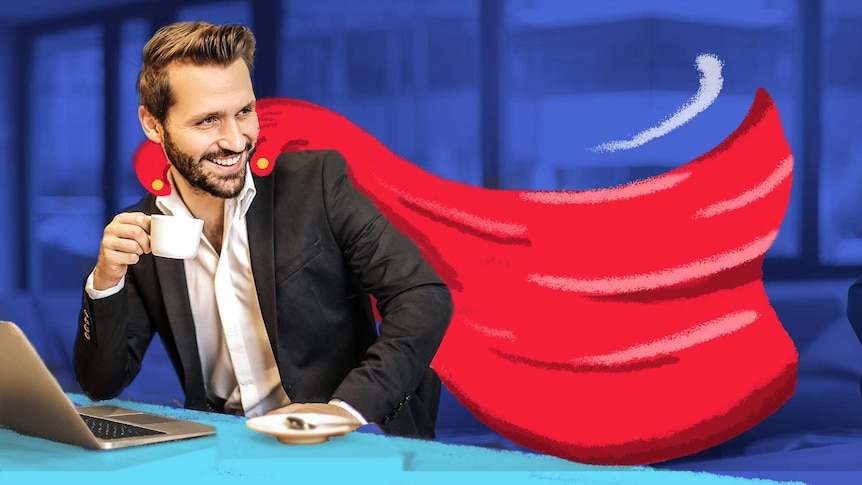 Young suited man in front of a computer, sipping coffee, grinning, with a drawn-on red cape to depict seeking approval at work