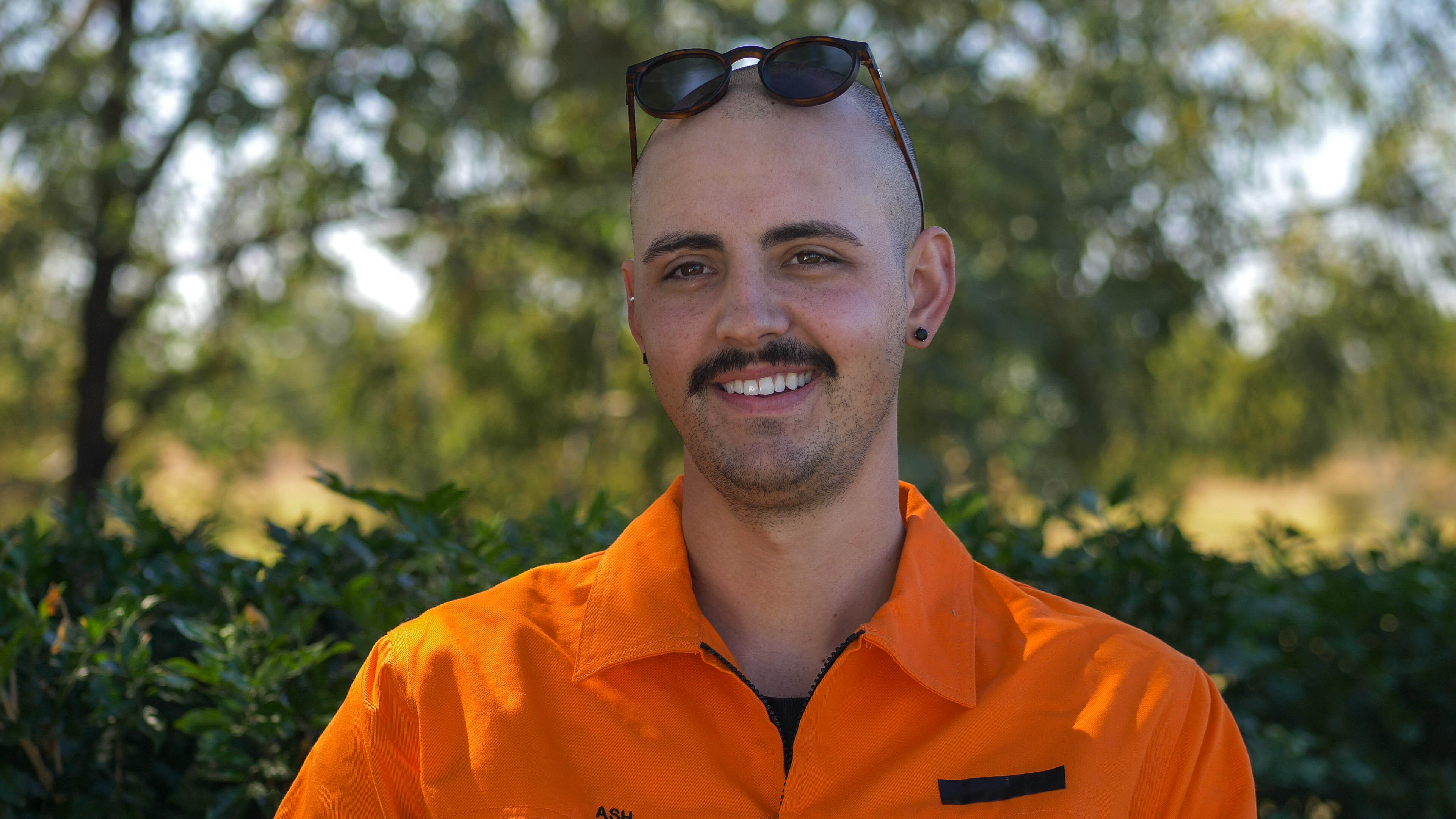 A man wearing an orange shirt.
