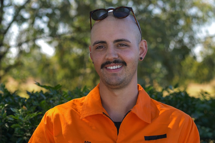 A man wearing an orange shirt.