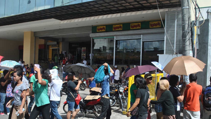 Residents in Tacloban City shop for food supplies ahead of Typhoon Hagupit