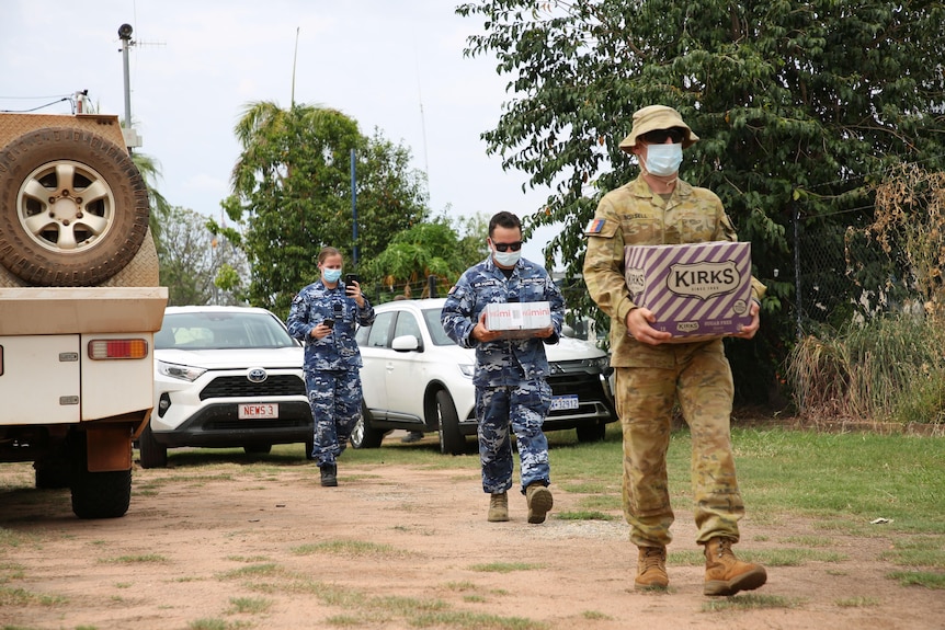 ADF personnel carrying drinks in boxes