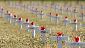 Small remembrance crosses cover the ground at the 90th Anniversary Remembrance Day service at the Shrine of Remembrance in Me...