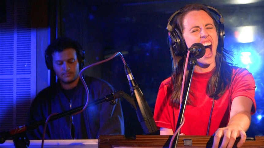 image of Gordi singing in the like a version studio