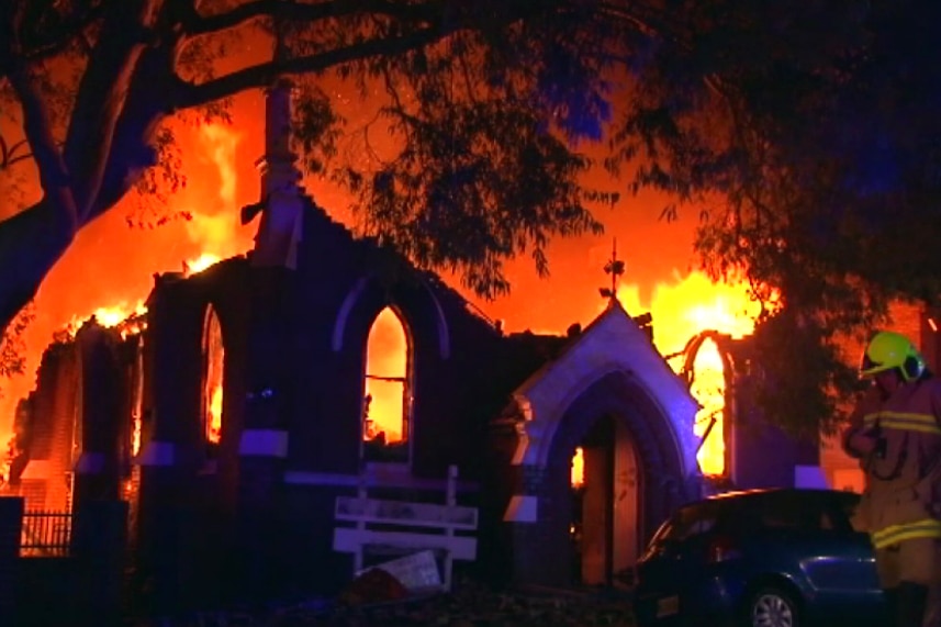 Large flames billow out of a church
