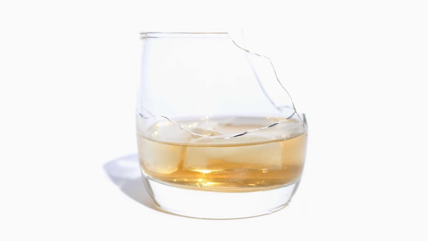 A cracked and broken whisky glass.