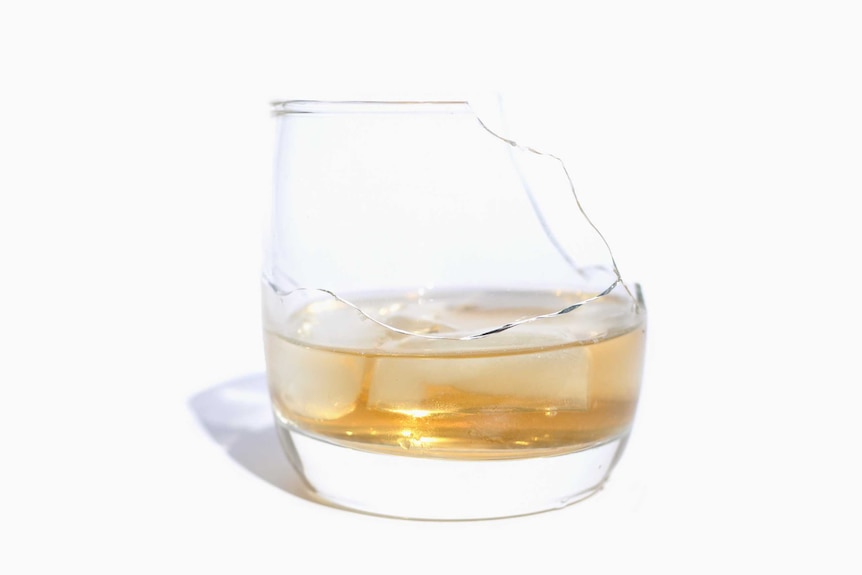 A cracked and broken whisky glass.