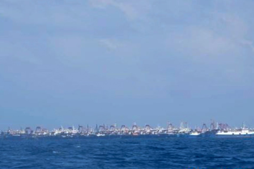 Some of the 220 Chinese vessels are seen moored at a distance at Whitsun Reef, South China Sea.