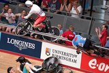 Crowd members scream as velodrome cyclists crash over railings