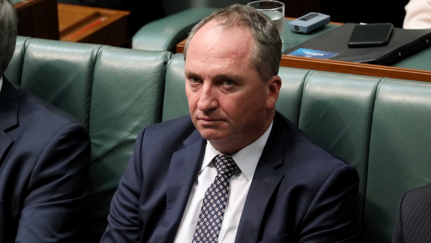Barnaby Joyce sits in the House of Representatives with a tired expression on his face. He frowns, with bags beneath his eyes.