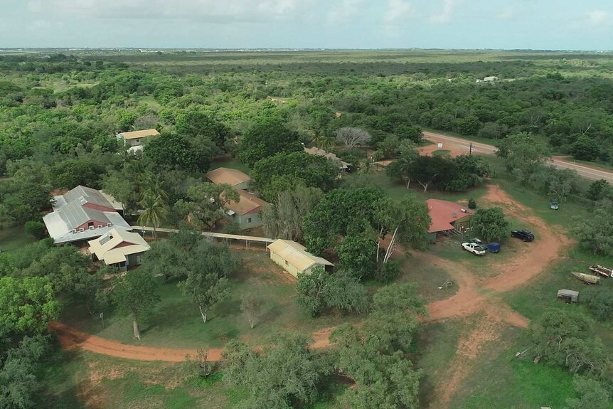 An aerial view of the buildings in a bush setting, with sky visible in the background