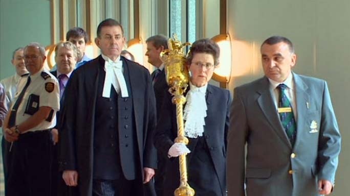 Peter Slipper follows the official mace on a formal procession through Parliament House