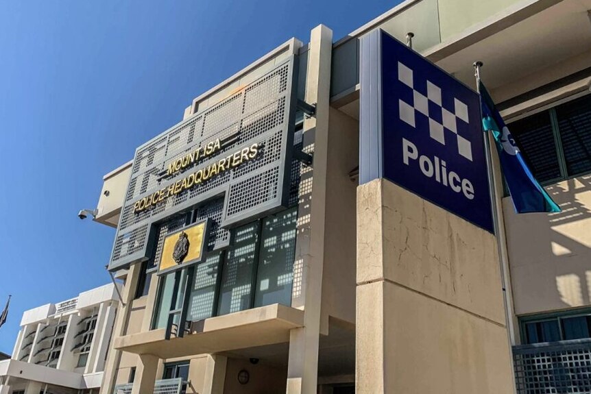 A large concrete police station with a sign saying Mt Isa Police Headquarters.