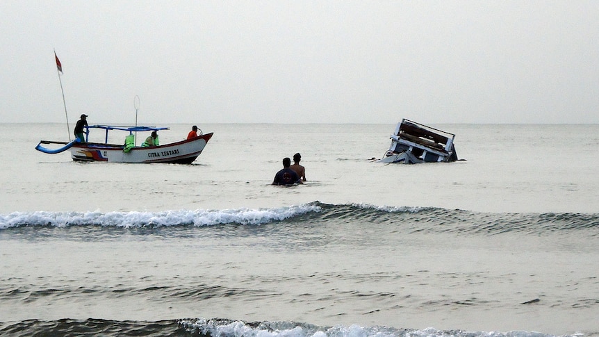 About 60 asylum seekers were on their way to Australia when their wooden boat sank in choppy seas.