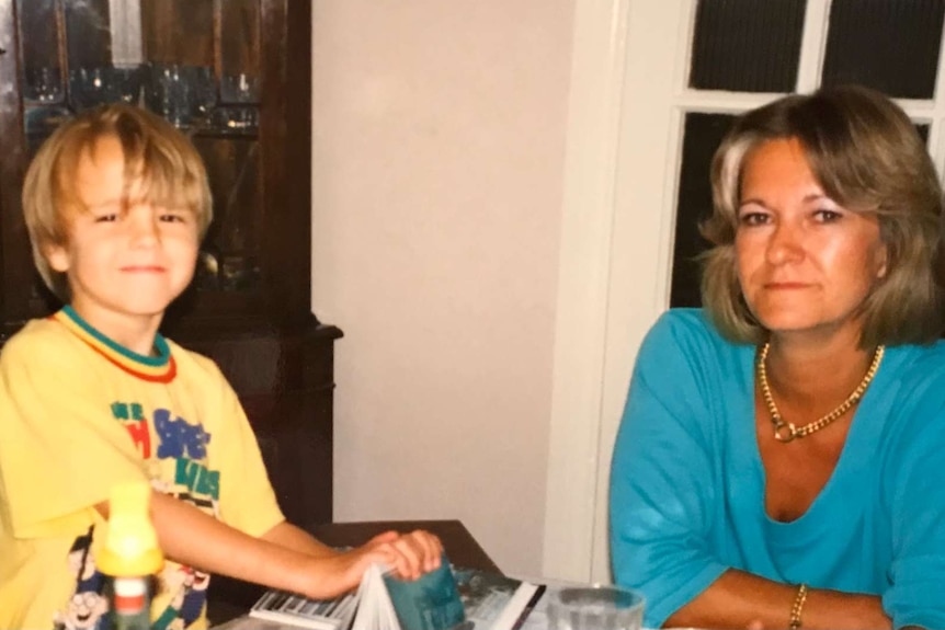 A photo of a woman in a blue top next to a little boy