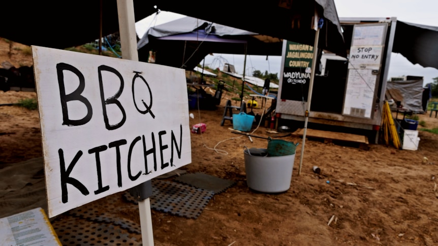 a trailer set up to be a kitchen, behind a sign saying "bbq kitchen"