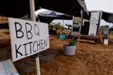 a trailer set up to be a kitchen, behind a sign saying "bbq kitchen"