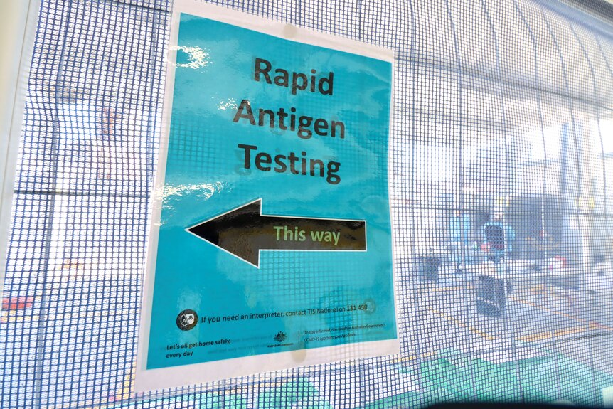 a sign saying rapid antigen testing at a building site