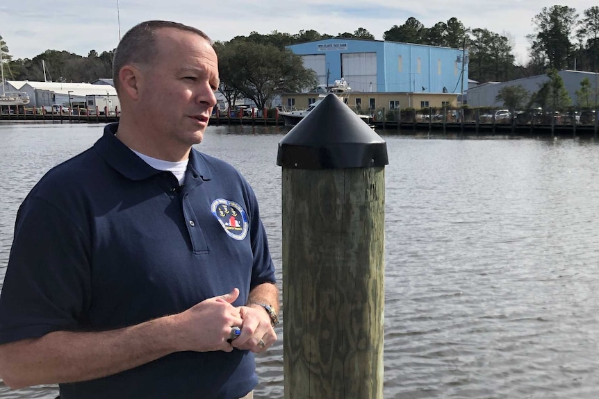 Shawn Burns standing by the water