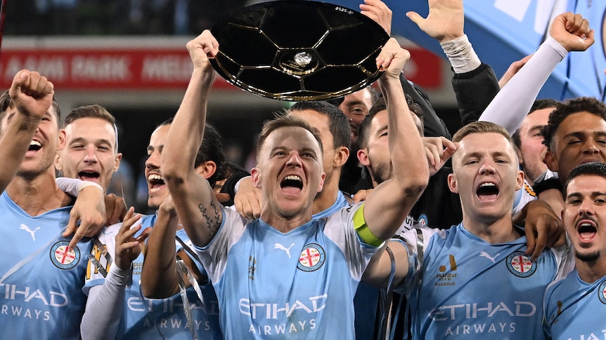 Scott Jamieson of Melbourne City holds up the Premiers Plate following the A-League Men's soccer match