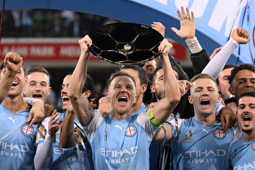 Scott Jamieson of Melbourne City holds up the Premiers Plate following the A-League Men's soccer match