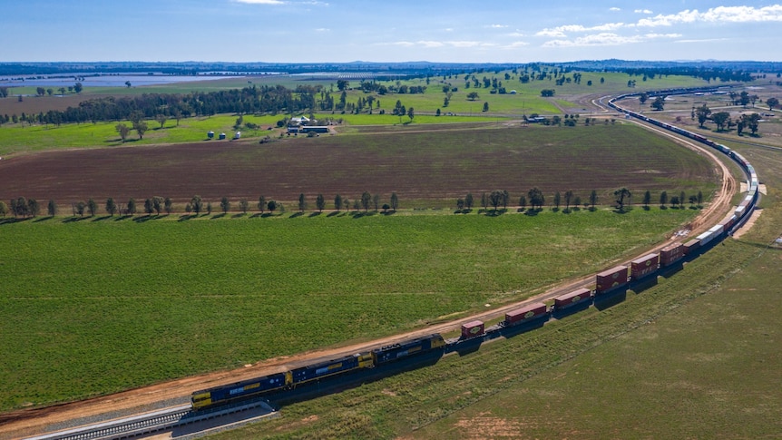 A long train snakes along the railway line somewhere near Parkes.