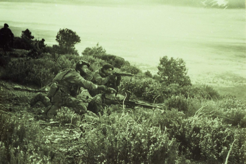 Foreign Legion soldiers fire their weapons during a conflict.