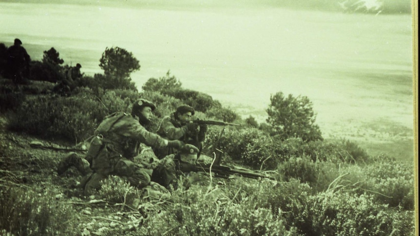 Foreign Legion soldiers fire their weapons during a conflict.