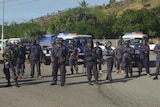 Heavily-armed Papua New Guinea police form a roadblock.