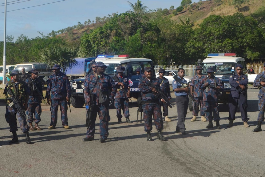 Heavily-armed Papua New Guinea police form a roadblock.