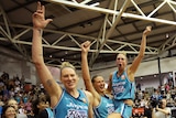 Carley Ernst, Rebecca Cole and Lauren Jackson hold up their hands