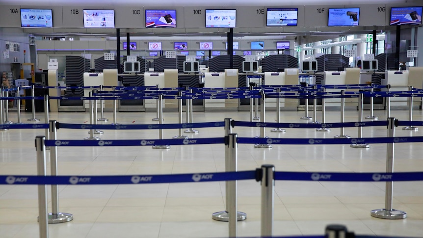 An airline counter sits empty as lockdown and travel restrictions are imposed in Bangkok
