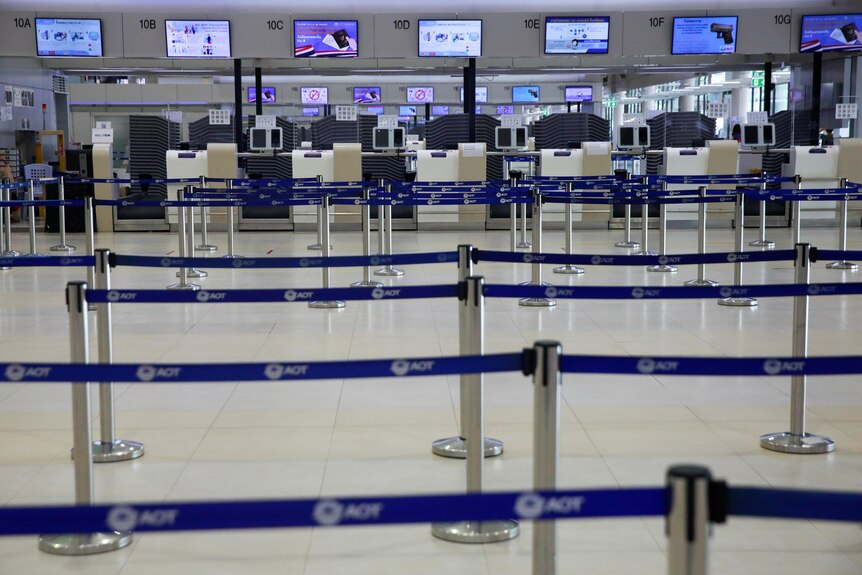 An airline counter sits empty as lockdown and travel restrictions are imposed in Bangkok