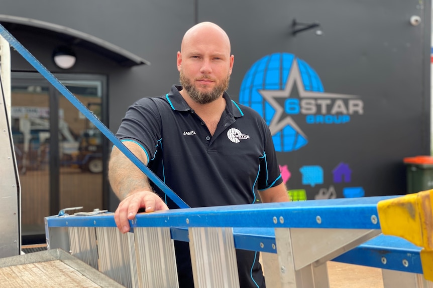 General Manager of electrical business 6 Star Group James Corea leaning on a ladder outside his business in Karratha.