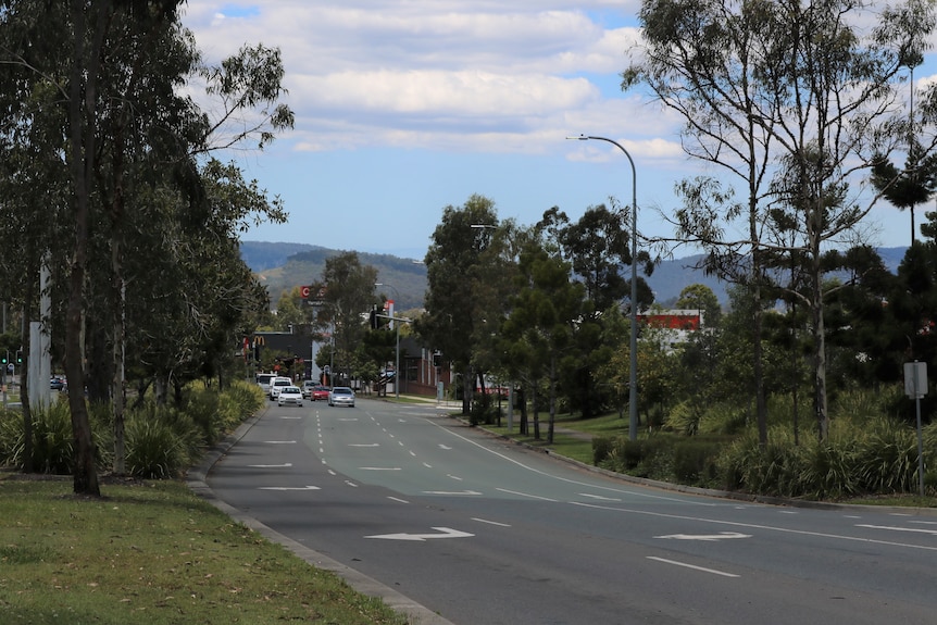A wide, quiet street, the entrance to Yarrabilba.