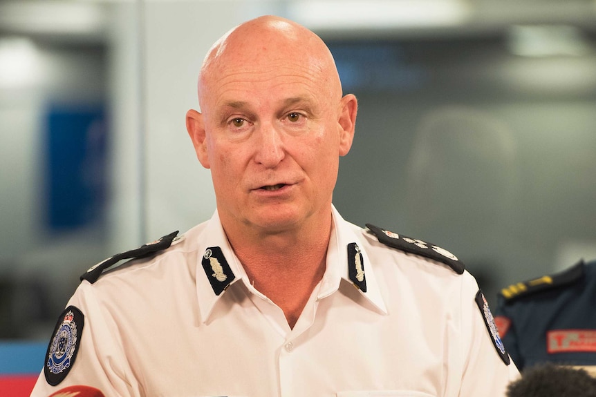 Craig Lapsley speaking at a lectern at a press conference.