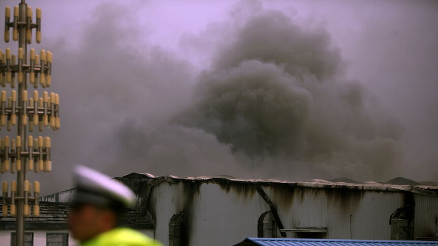 Smoke rises from a Baoyuan poultry plant which caught fire at Dehui, in Jilin province in north-east China.