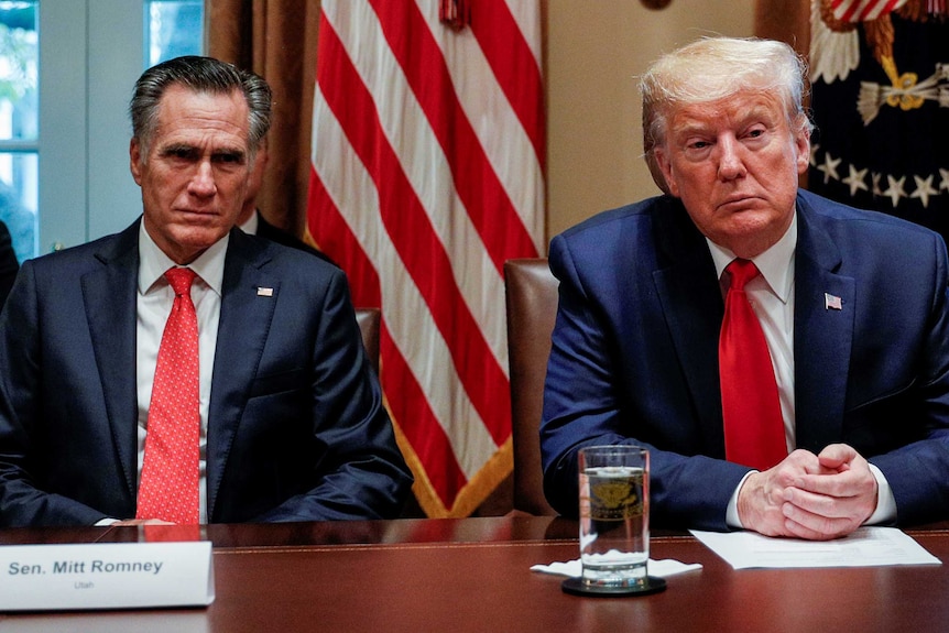 Mitt Romney and Donald Trump in the White House cabinet room looking serious