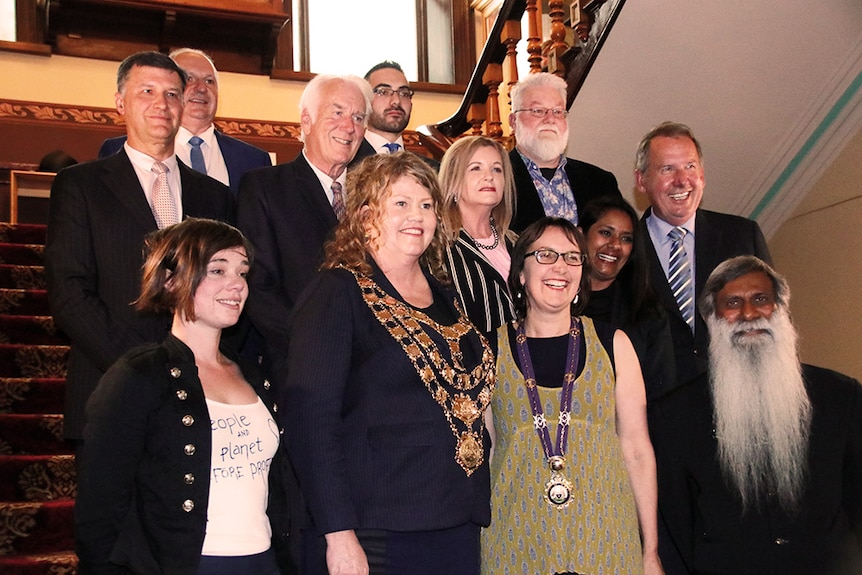 Hobart City Council aldermen pose for a photo on stairs