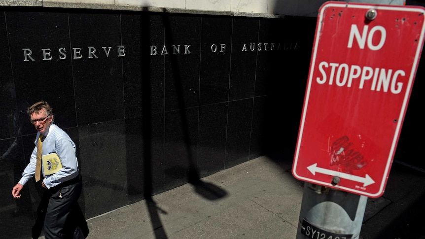 A pedestrian passes the Reserve Bank building