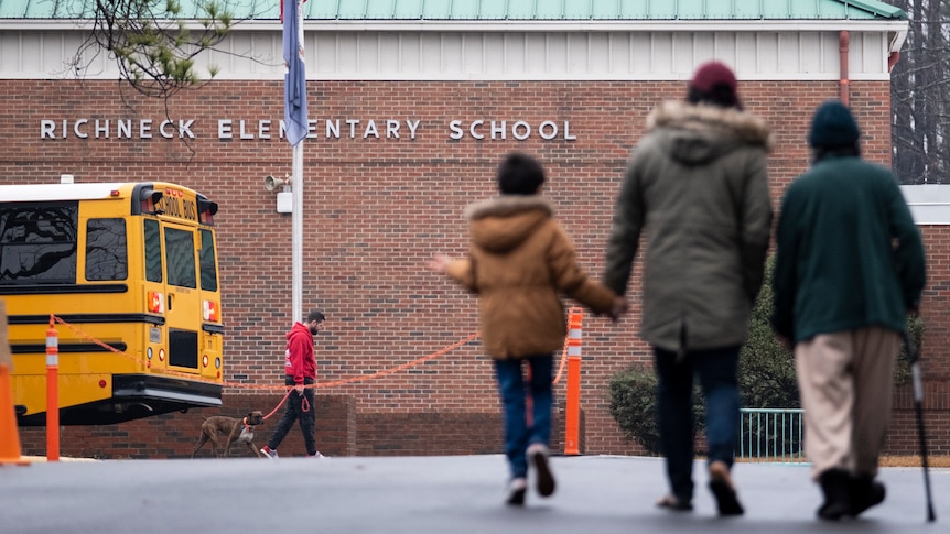 children walk towards the entrance of Richneck Elementary following a shooting in January