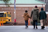 children walk towards the entrance of Richneck Elementary following a shooting in January