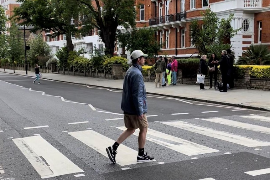 Chris Ross walks across a zebra crossing