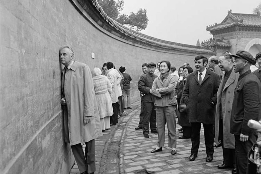 Gough Whitlam putting his ear against the echo wall in China.