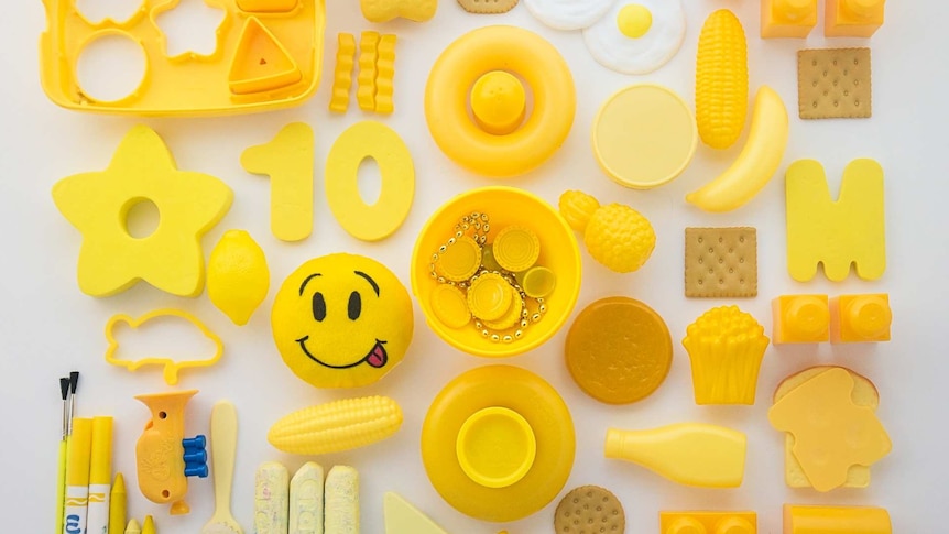a collection of yellow children's toys